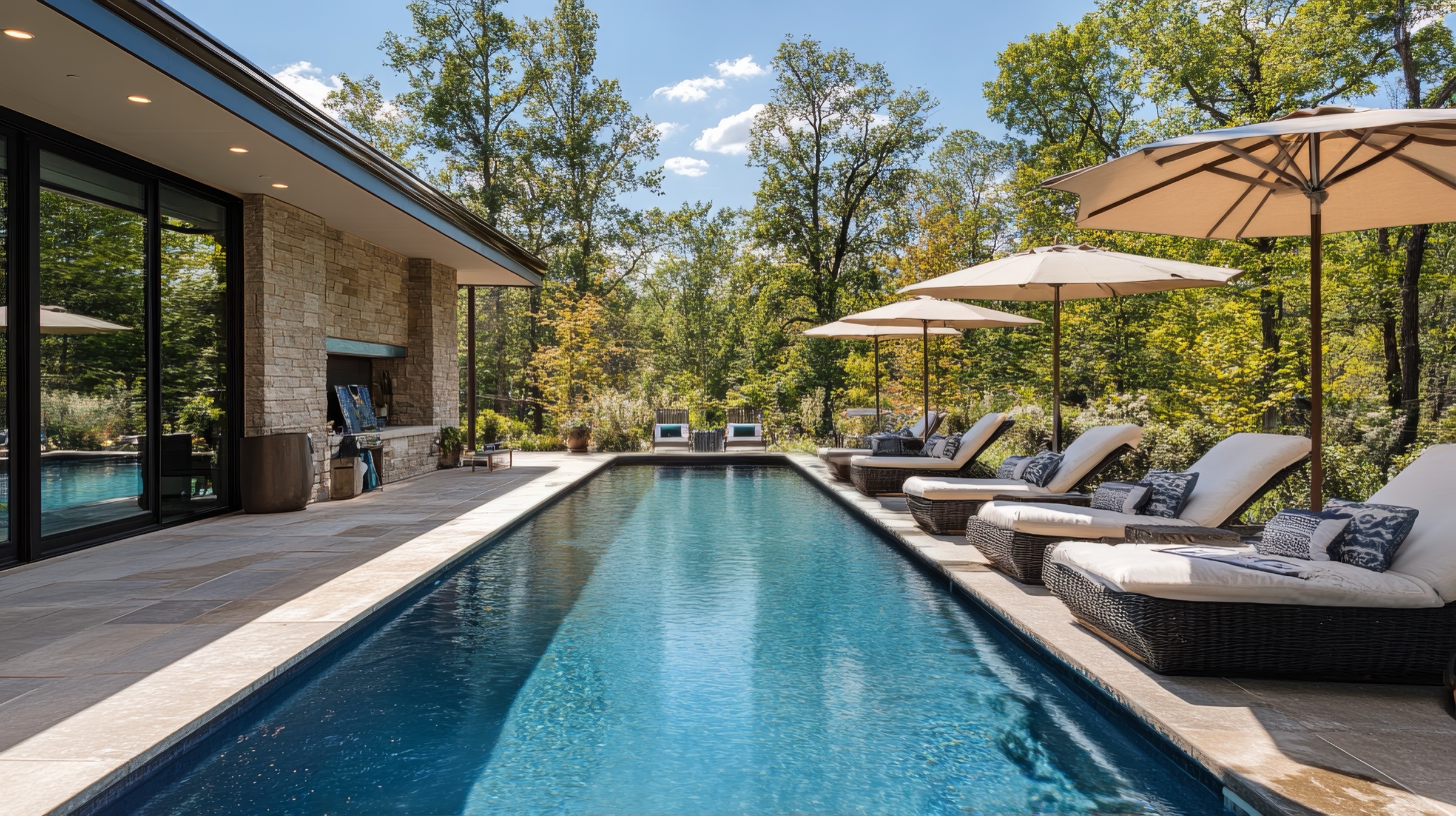 Inground swimming pool with stone deck by Montreal pool builders